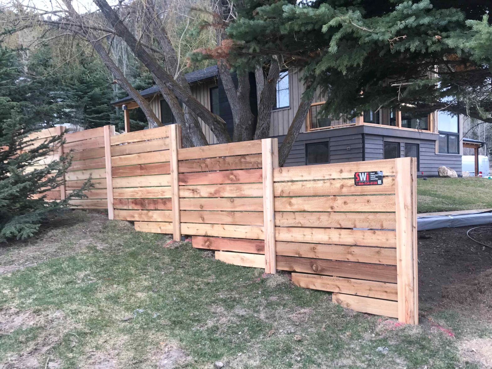 Photo of a wood fence installed on an incline in Wyoming